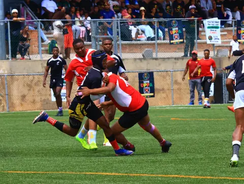 Ball carrier being tackled during play.