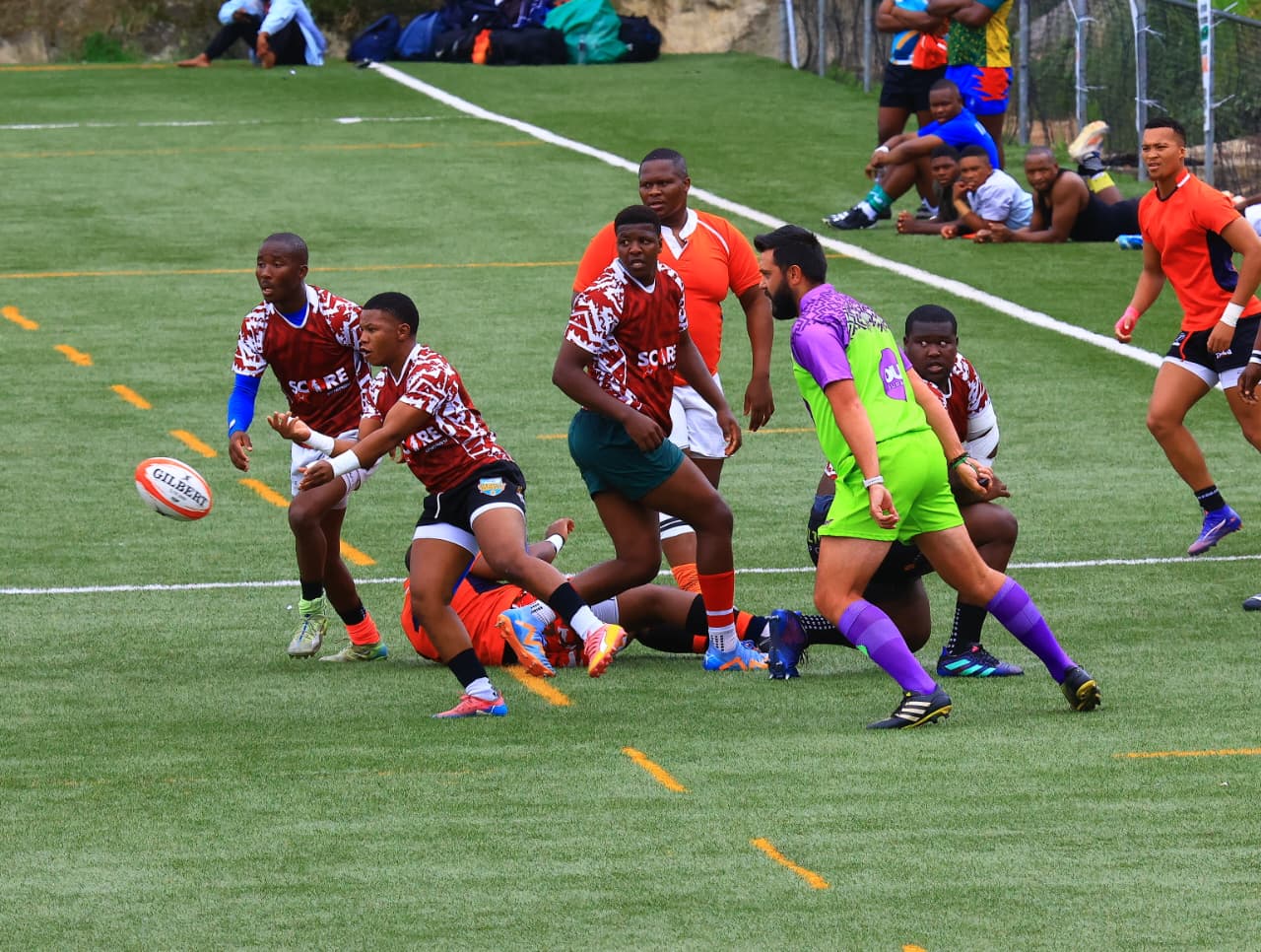 A pass during play, with the ball visible to the left of the players.