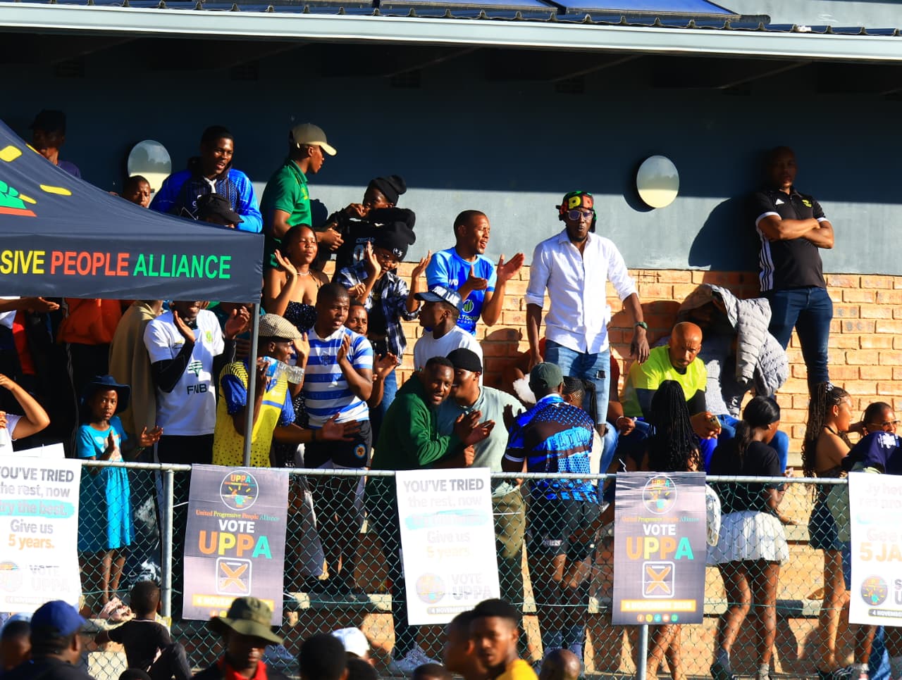 Spectators watching and applauding beside the playing area.